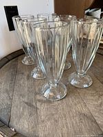 Photo showing six vintage diner milkshake glasses arranged in two rows