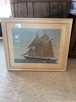 Full view of framed photograph print showing the Bluenose II sailing with all sails deployed.