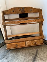 Front view of wooden hanging entry tray showing eagle decoration and drawers.