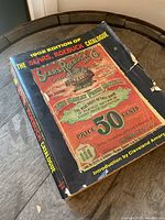 Front cover of the 1902 Sears Roebuck Catalogue Recreation showing vintage advertising graphics and the title with wear and damage visible.