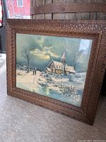 Full view of framed vintage print showing snowy landscape and church in moonlight.