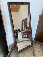 Full front view of the rectangular mirror showing the tortoiseshell style frame and reflective surface.