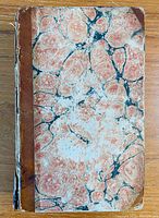 Front cover of 1810 Nathan Drake essays book with marbled paper and leather spine.