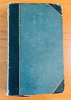 Front cover of the bound volume showing blue leather with darker blue spine and corner accents, gilt edging visible, condition shows wear and tear.