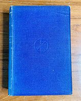 Front cover of the book showing blue cloth binding with embossed circular design.