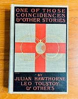 Front cover of the book showing the title, authors, and decorative red cross with golden spider design