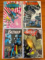 Photo of four Batman comic books including issues #415, #425, #439, and #441 laid out in two rows showing front covers with varying artwork styles and titles.
