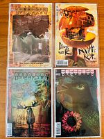 Photo of four Dreaming comic issues #5, #15, #16, #24 showing front covers featuring art by Dave McKean and others, displaying surreal and fantasy themes.