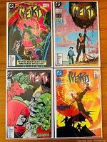 Four The Weird comic books laid out in pairs, showing front covers with bright, colorful artwork featuring characters and energy effects.