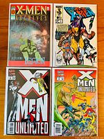 Top-down photo showing four Marvel comic books: X-Men Archives #1, Heroes for Hope #1, X-Men Unlimited #4, and X-Men Unlimited #6 laid flat on a wooden surface.