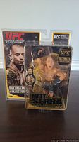 Front view of UFC Matt Serra action figure in original packaging showing figure with championship belt and UFC Ultimate Collector branding.