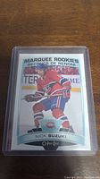 Front of Nick Suzuki rookie hockey card showing player image and team logo