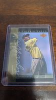 Front of the Tiger Woods rookie card showing Tiger mid-swing with 'Tiger's Tales' title and gold strip.