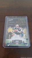 Front of Tom Brady NFL Prestige Any Given Sunday trading card showing player image, game score Patriots 20 vs Rams 17 and logos.