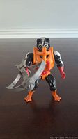 Front view of vintage 1980s Stinkor action figure with orange harness and weapon