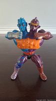 Front view of vintage Two Bad action figure showing blue and purple heads, orange chest armor, and detailed paint on limbs.