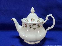Full view of the Royal Albert Winsome bone china teapot with lid in place, showing floral pattern, shape, and gold trim.