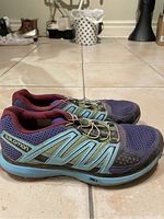 Side view of the pair of Salomon women's city trail hiking shoes showing colors and design