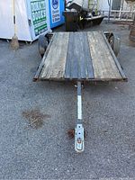 Front view of trailer showing steel tongue hitch and wooden deck condition