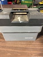 Closed view of gray and black Craftsman tool box with handle and visible Craftsman branding.