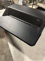 Side view showing the flat surface and the groove for holding devices with Fellowes branding visible.