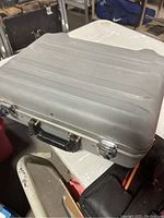Closed view of the gray metal tool case with handle and clasps
