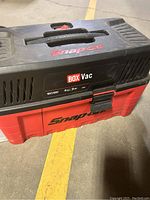 Top and side view showing Snap-On branding, Black and red colors, BOX Vac label with specifications.
