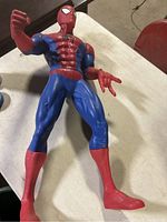 Full body photo of the 30" Spider-Man figure standing on a table, showing articulated limbs and costume colors.