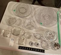 Full view of all glassware items laid out on a table showing assortment and variety