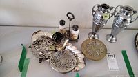Wide view of the lot showing the oval tray, salt and pepper set with tray, and various trivets and candle box.