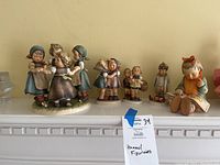 Front view of entire lot on mantel showing all five figurines