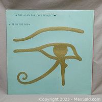 Front cover of 'Eye in the Sky' album with turquoise background and gold Eye of Horus symbol.
