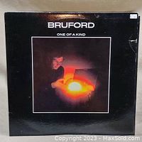 Front cover of vinyl album showing Bill Bruford with glowing orb, titled 'Bruford One of a Kind'.
