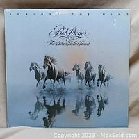 Front cover of album 'Against the Wind' by Bob Seger and the Silver Bullet Band, featuring five horses and artist/title text.