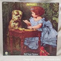 Front cover of the Vinyl LP album 'Mongrel' by Bob Seger System showing an illustrated young girl and dog playing at a small table, with album title and artist name.