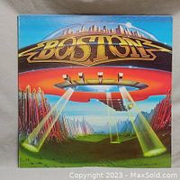 Front cover of 'Don't Look Back' album featuring Boston's iconic spaceship shaped like a guitar against a colorful alien landscape.