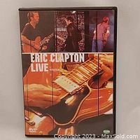 Front cover of Eric Clapton Live DVD showing Eric Clapton playing guitar and various images of his performance.