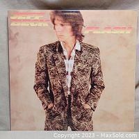 Front cover of Jeff Beck 'Flash' vinyl record album showing Jeff Beck in a patterned jacket.