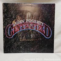 Front cover of the John Fogerty 'Centerfield' vinyl album showing the title and artwork with some surface wear.