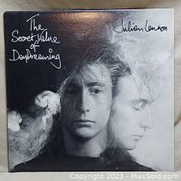 Front cover of 'The Secret Value of Daydreaming' album by Julian Lennon showing monochrome double portrait of the artist with handwritten title and name.