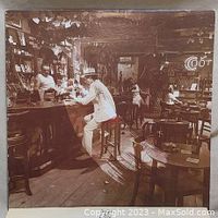 Front cover of the album featuring a bar scene with man at the bar and other patrons in background, in sepia tone.
