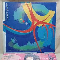 Front cover of Robert Plant's 'Shaken 'N' Stirred' vinyl LP album with abstract blue artwork.