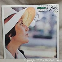 Front cover of the vinyl LP record showing Joan Baez in profile with a large straw hat, album title, and printed signature.
