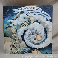 Front cover of the vinyl LP showing surreal cosmic artwork with Albert Einstein and planets, titled 'The Moody Blues - A Question of Balance'