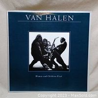Front cover of Van Halen Women and Children First vinyl record album, dark blue background with photo of band members.