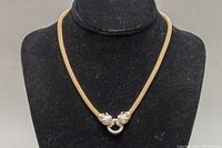 Full view of the gold-toned mesh choker necklace displayed on black velvet bust. The necklace has a 16-inch length, with tiger heads clasp detail at the center front.