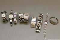 All nine watches displayed in a row showing variety of bracelet styles and sizes