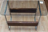 Top view of the accent table showing the smoked glass surface, chrome frame, and wooden panels.