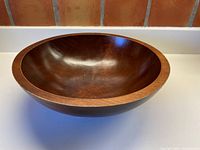 Side angled view of the solid maple Baribocraft bowl showing smooth finish and round shape.