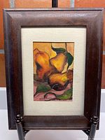 Frontal view of the framed watercolour painting showing the pears artwork inside a wooden frame and cream matting.
